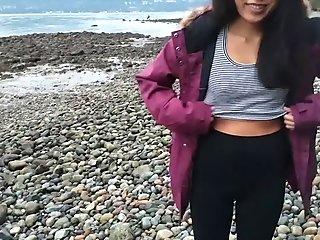 Asian teen gives blowjob and flashes on public beach